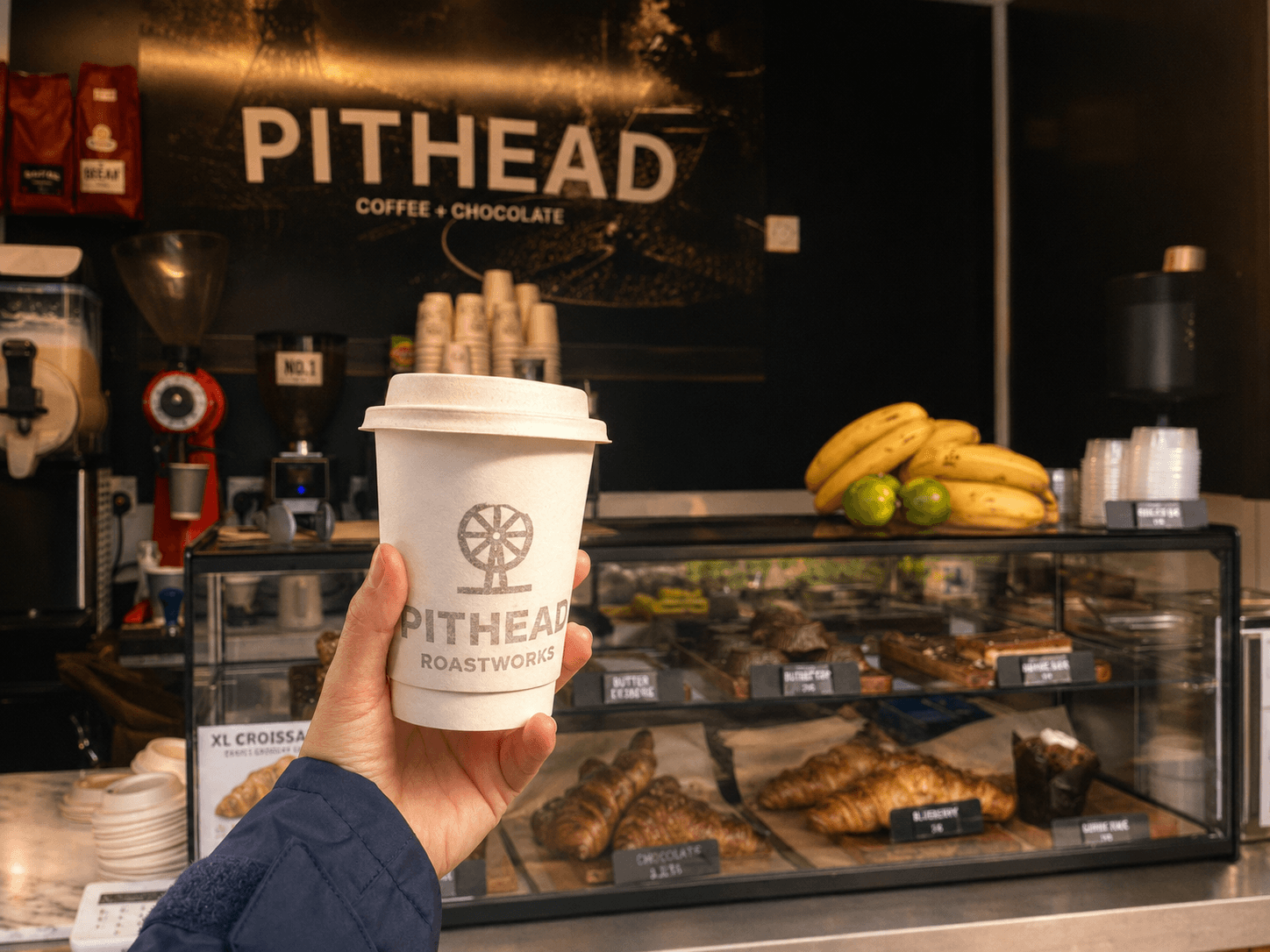 A cup of coffee held in hand at Pithead